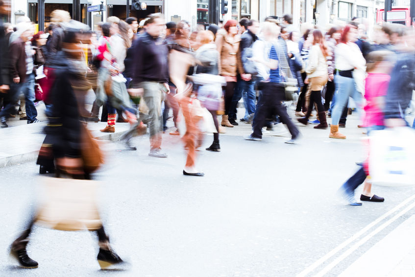 shopping crowd crossing the city street in motion blur