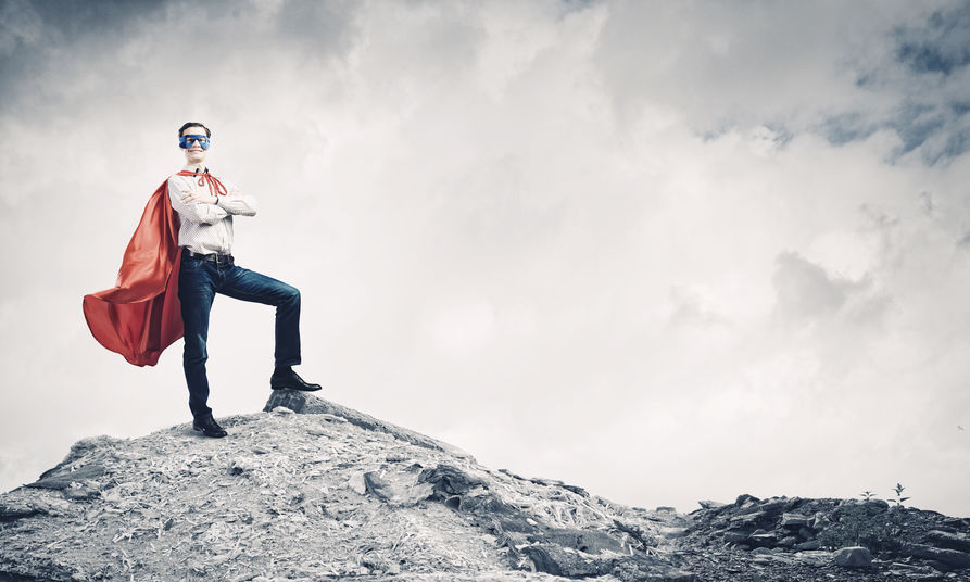 Man in jeans, shirt, as confident hero, with a cape